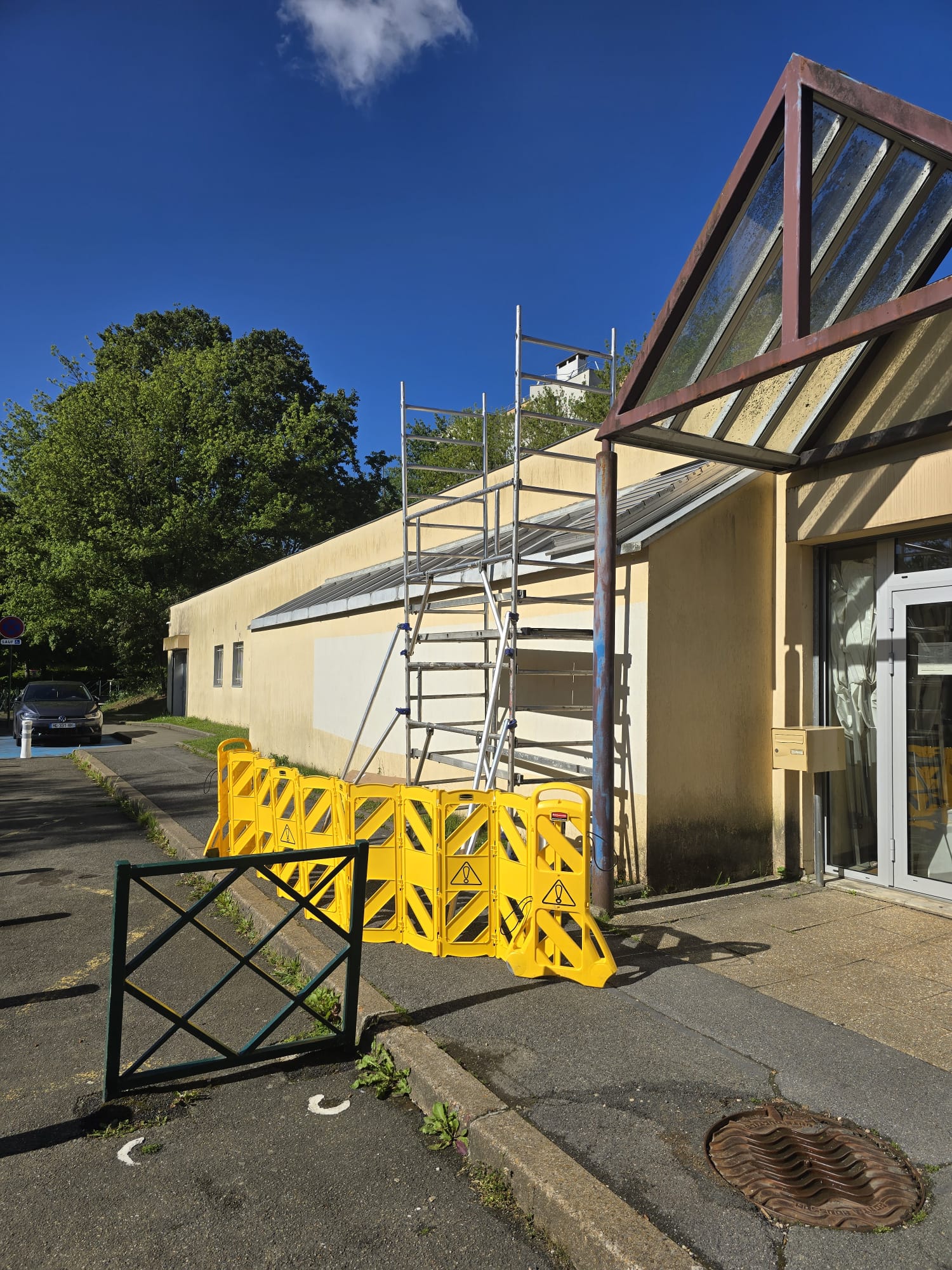 Échafaudage déployé contre la façade du studio Solarscène pour la pose en hauteur du film solaire sur la verrière — barrières chantier jaunes au sol, DFP France